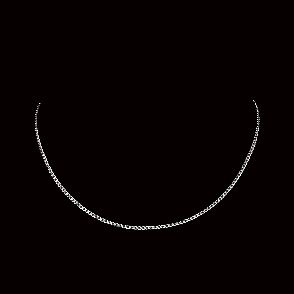 Silver chain necklace against a black background.