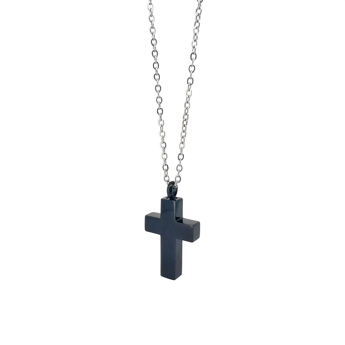 Dark cross pendant on a silver chain necklace.