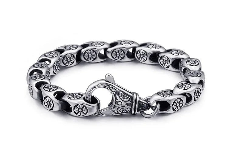 Silver bracelet with patterned links and an ornate clasp.