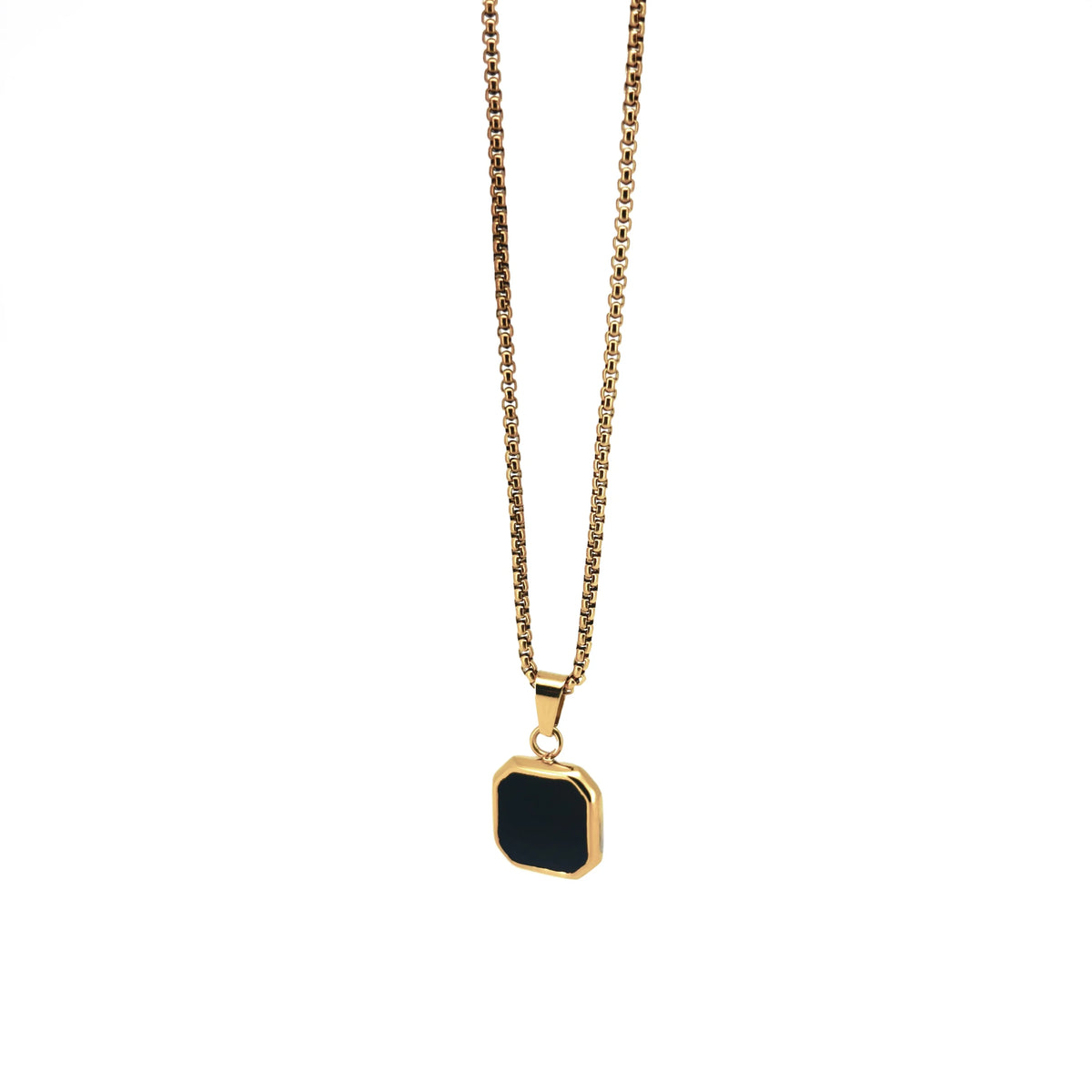 Gold necklace with a square black pendant.