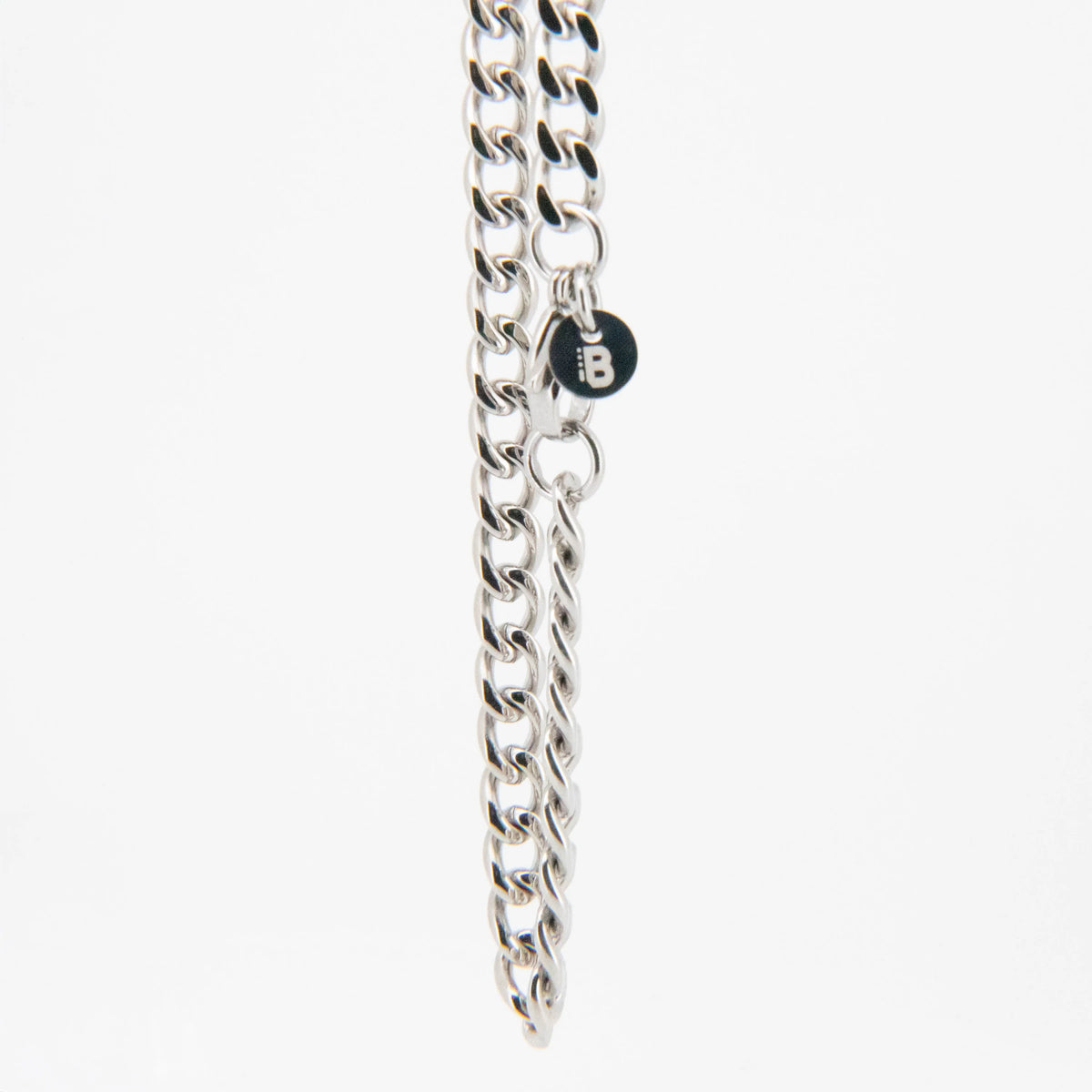 Silver metal chain necklace with a small round pendant.