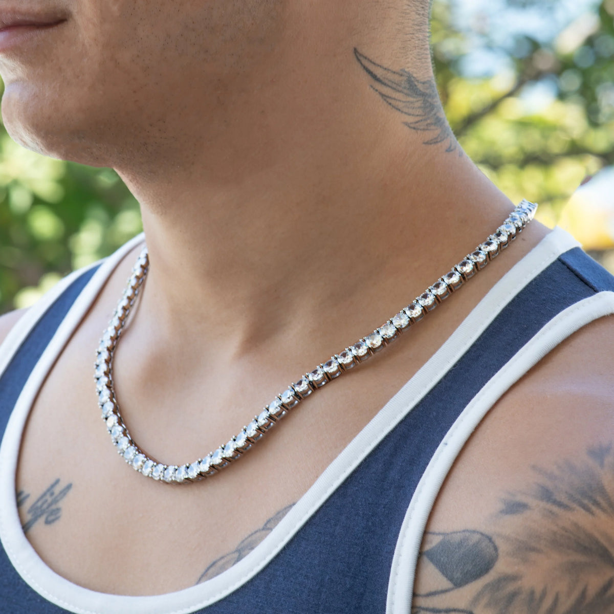 Sparkling diamond tennis necklace worn around a person’s neck.