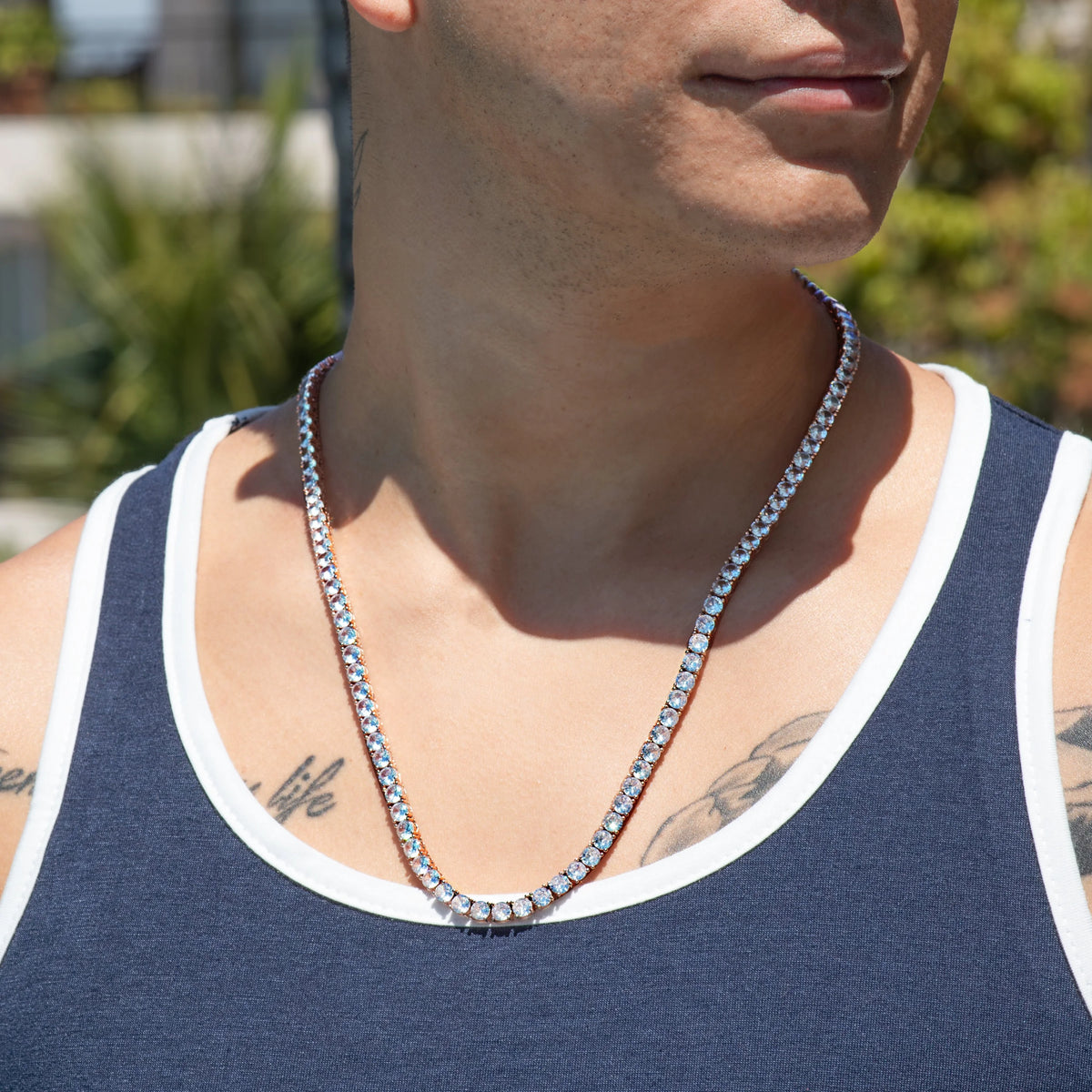 Diamond tennis necklace worn around a person’s neck.