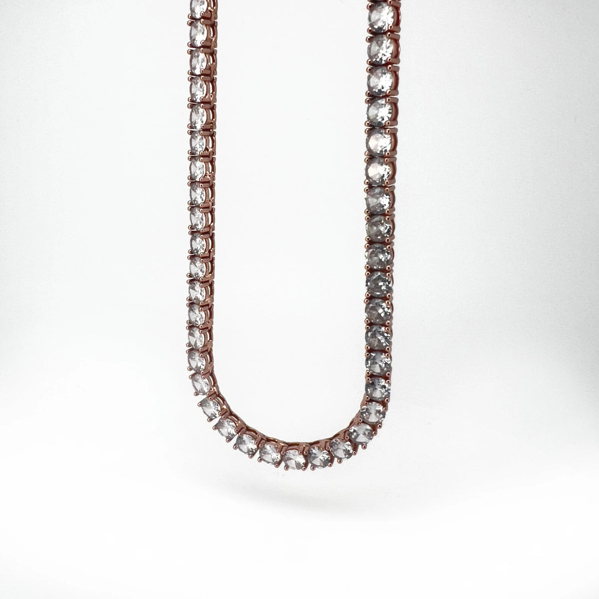 Diamond tennis necklace with a rose gold setting.