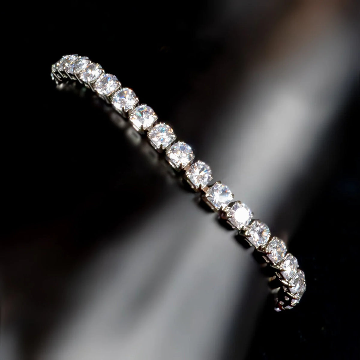 Diamond eternity band with round brilliant cut stones set in a white metal.