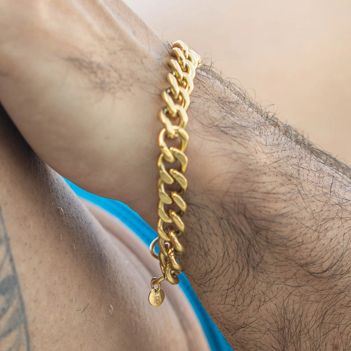 Gold chain bracelet with interlocking links.