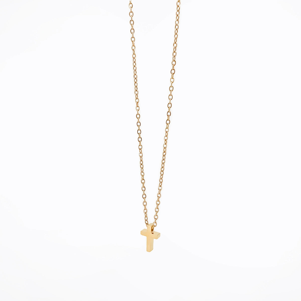 Gold necklace with a small cross pendant.