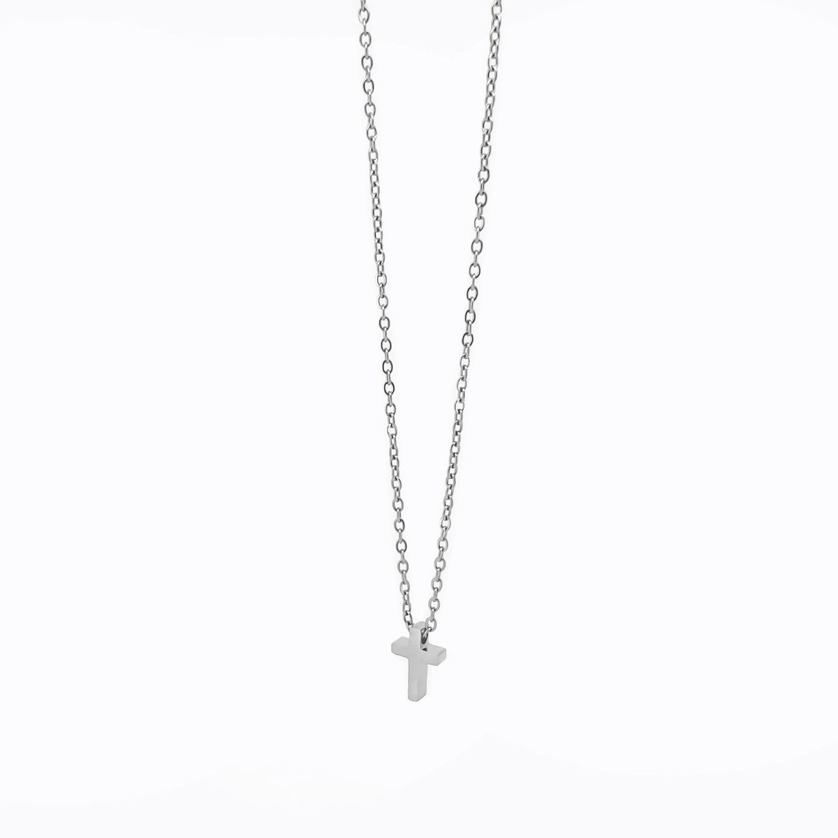 Silver necklace with a small cross pendant.