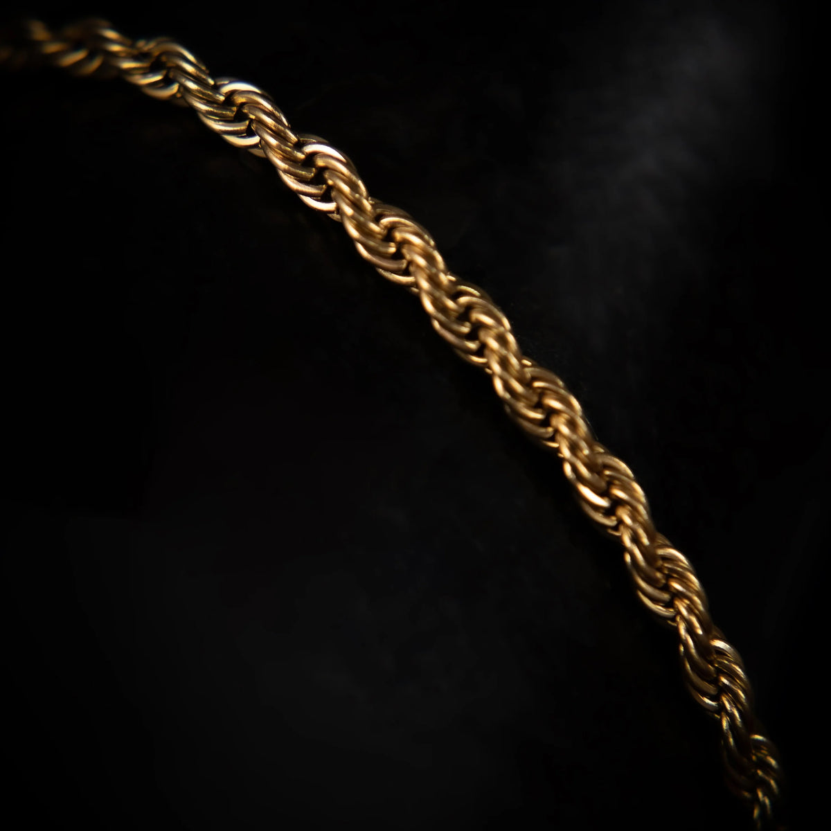 Gold rope chain necklace with a twisted pattern.