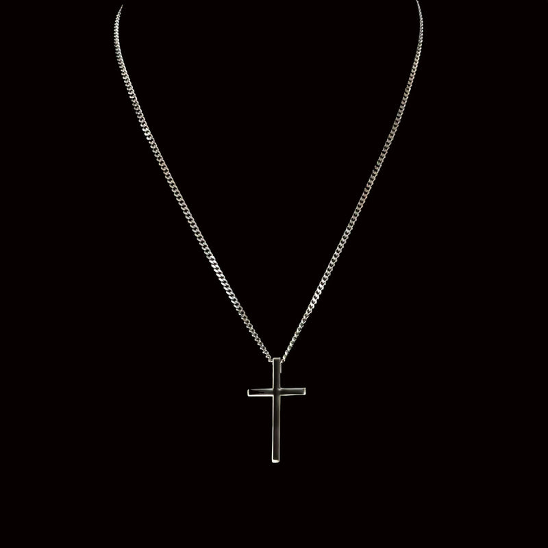 Silver cross pendant on a delicate chain necklace.