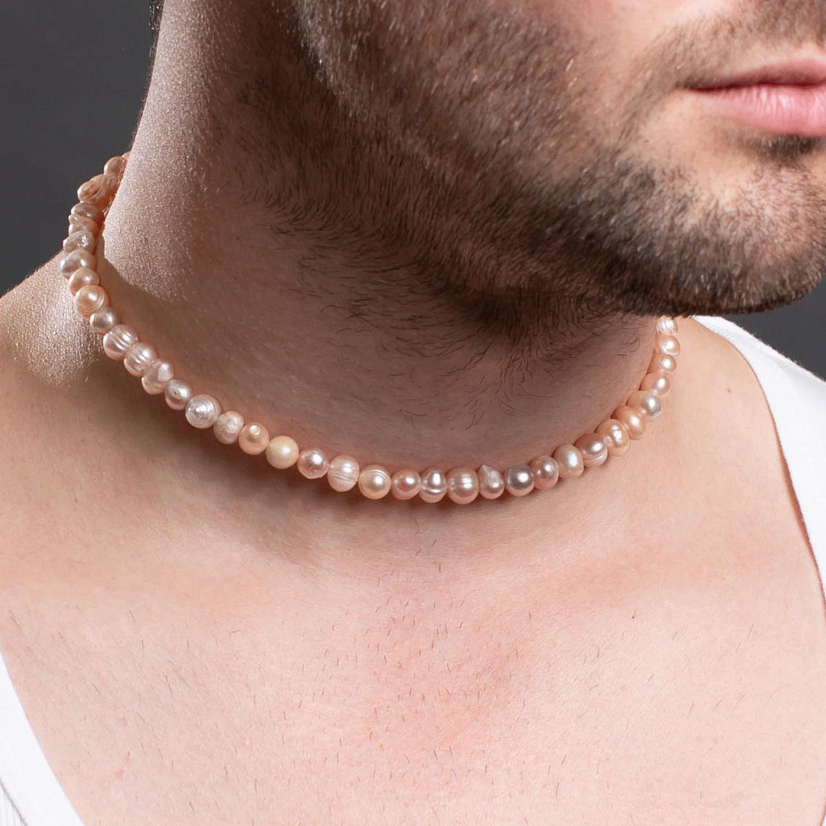 Pearl necklace worn around a person’s neck.