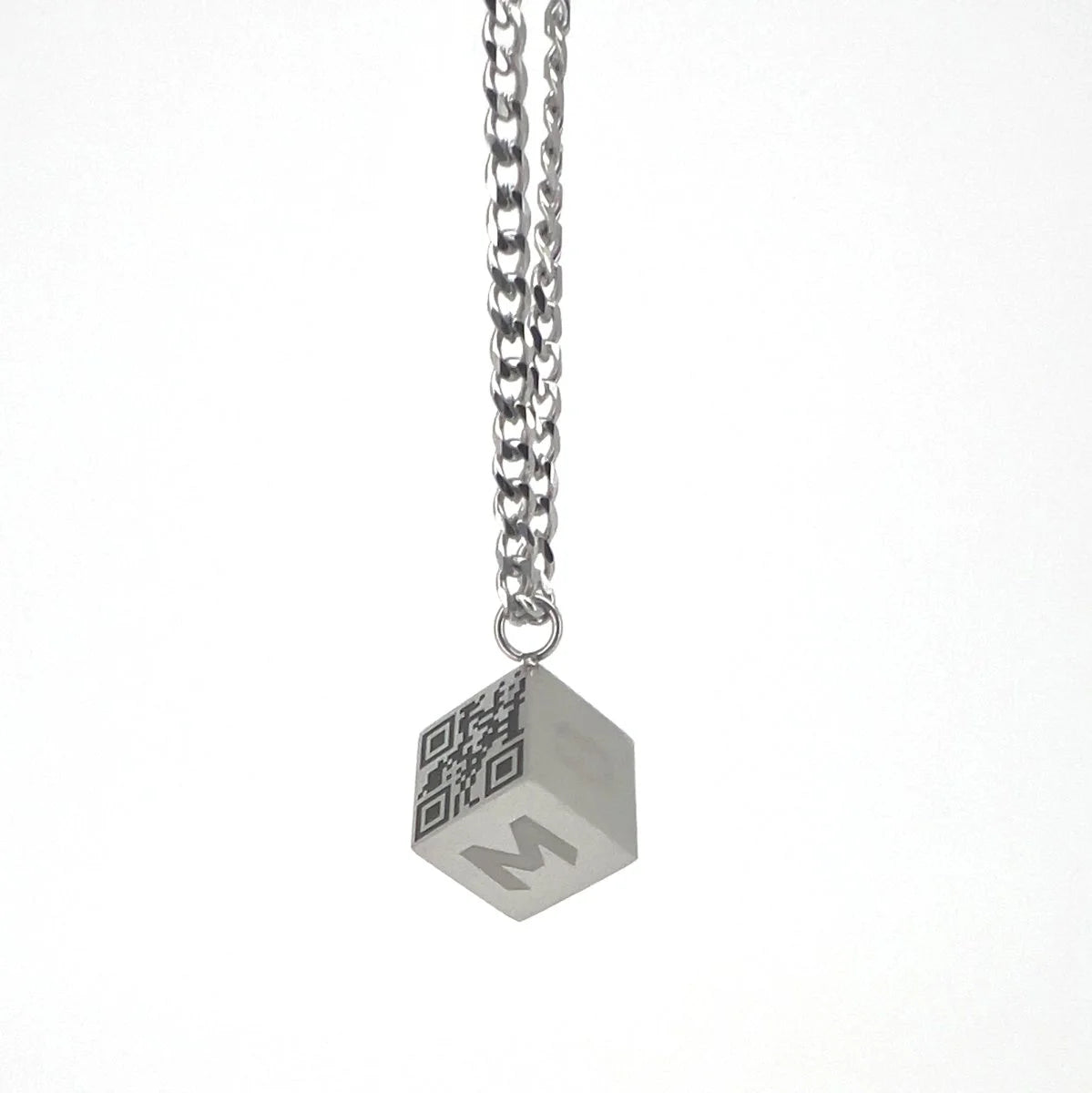 Cube-shaped pendant with a QR code and letter ’M’ hanging from a silver chain.