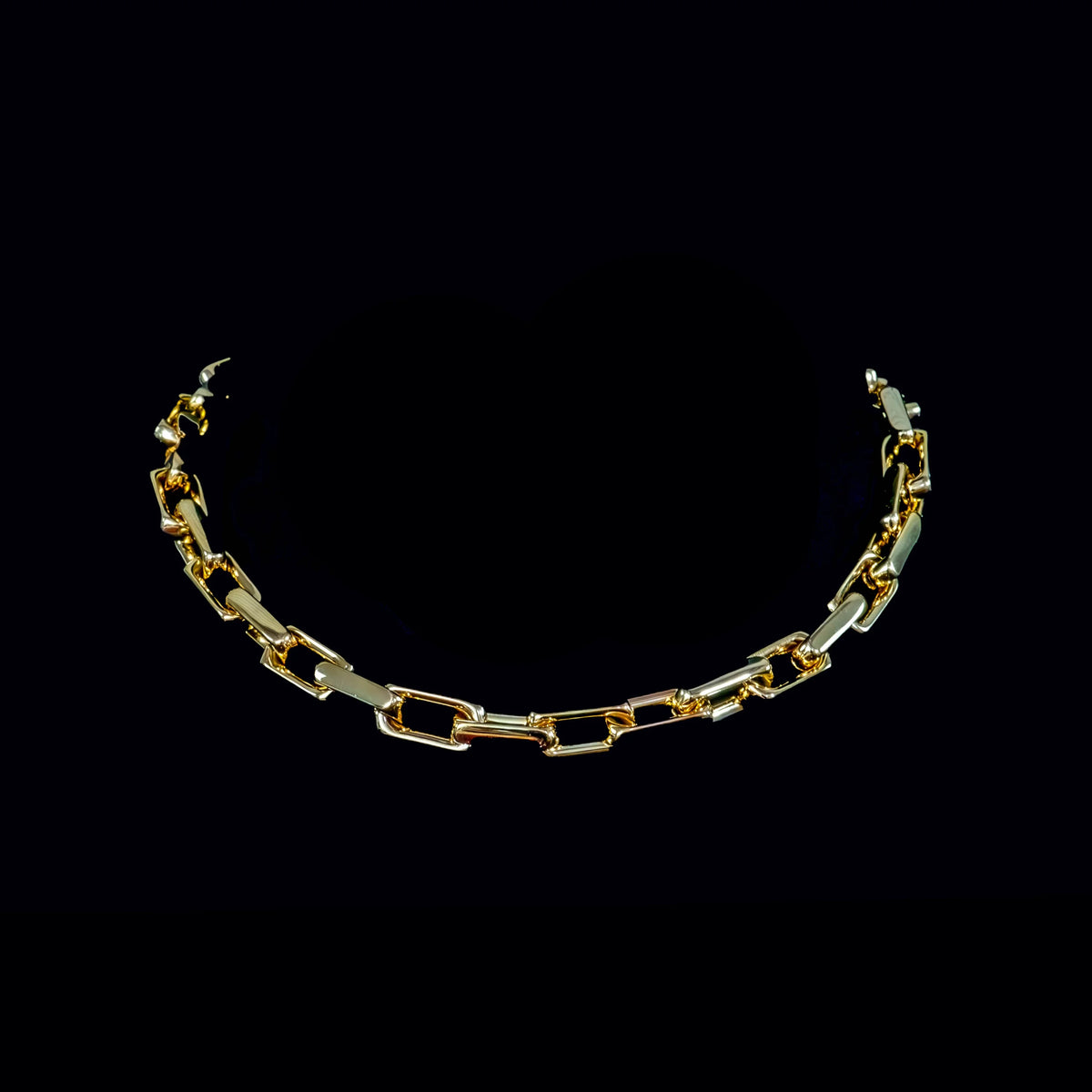 Gold chain necklace with rectangular links.