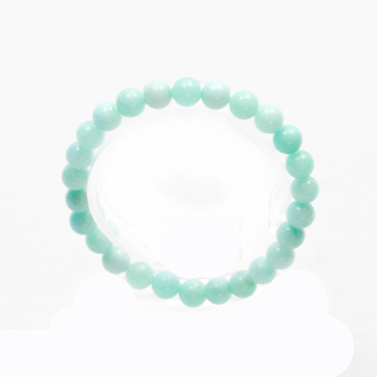 Mint green beaded bracelet or elastic band.