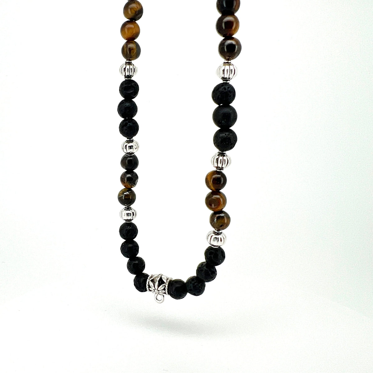 Beaded necklace with black, brown, and silver-colored spheres arranged in a pattern.