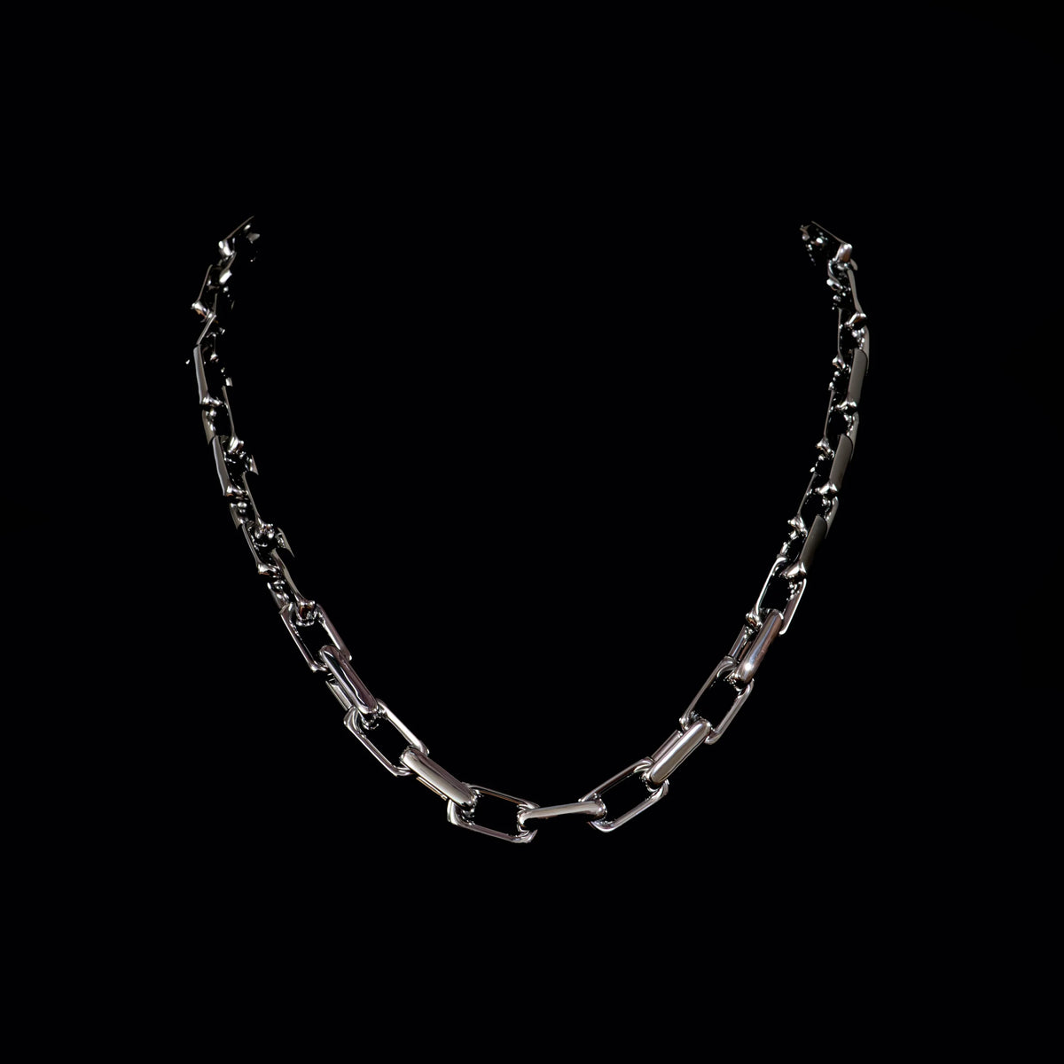 Silver chain necklace with rectangular links.