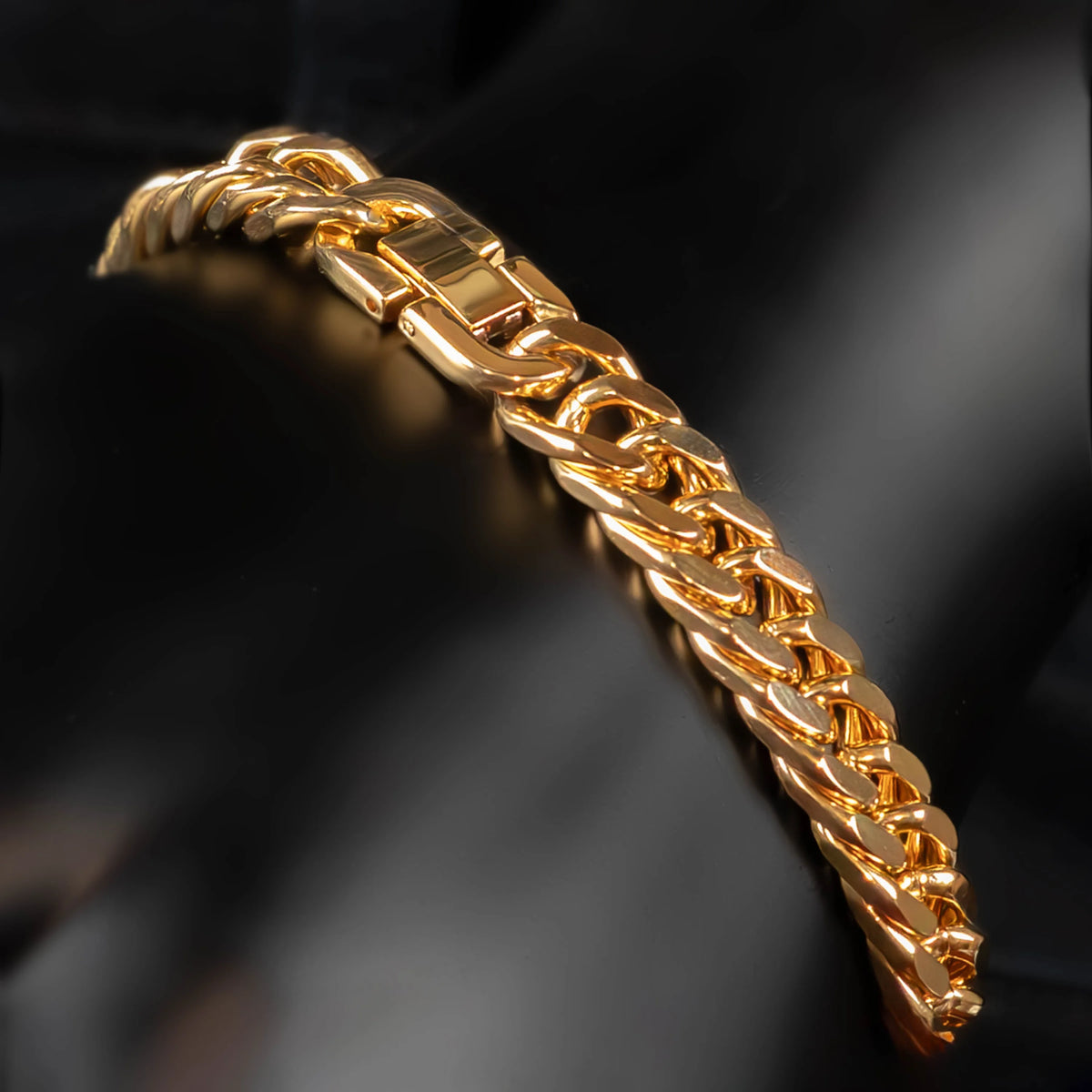 Gold chain bracelet with interlocking links and a clasp.