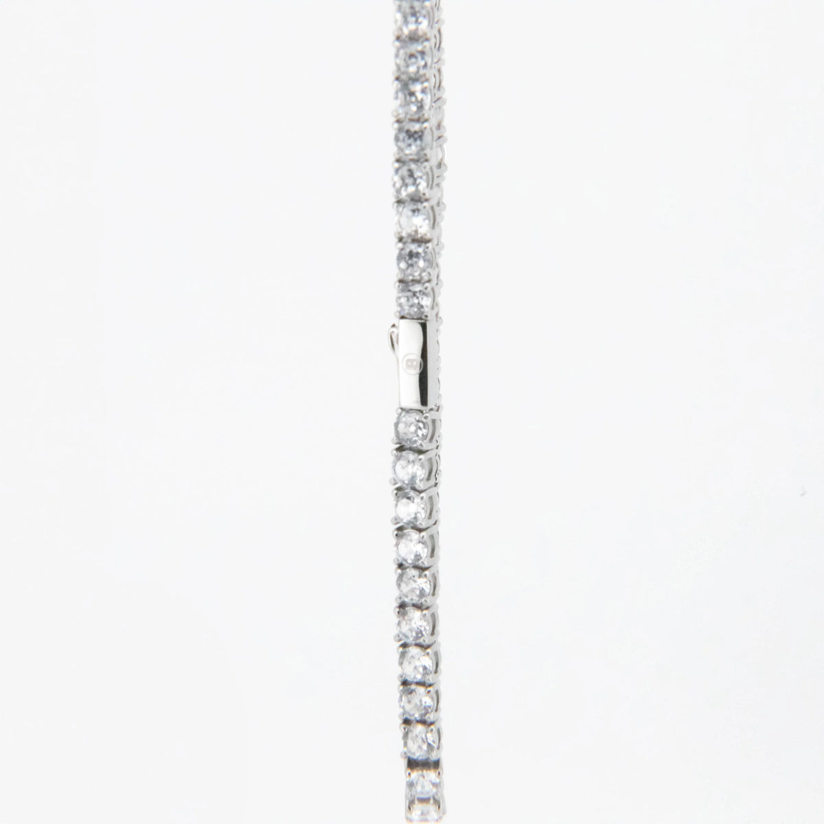 Silver tennis bracelet with clear gemstones set in a line.