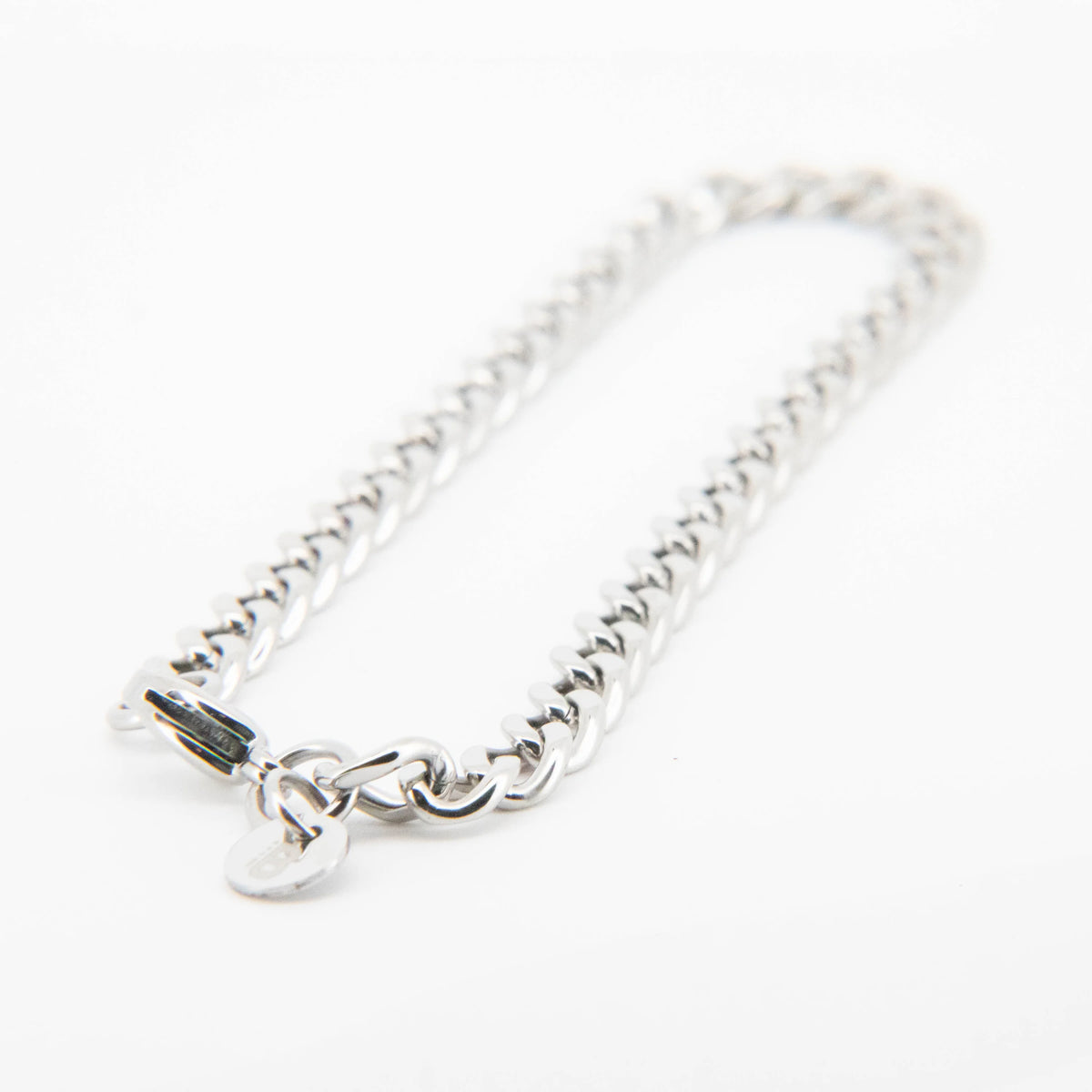 Silver chain bracelet with a heart charm.