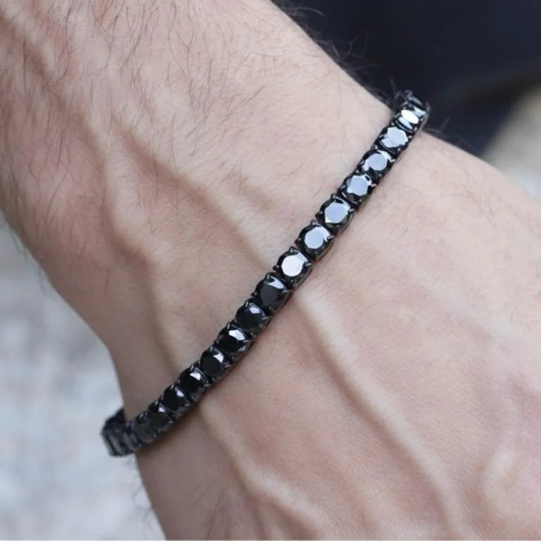 Black diamond tennis bracelet with a sleek metal band and shiny gemstones.
