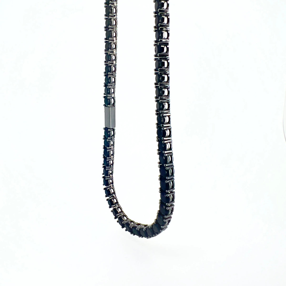 Dark metallic chain necklace with square-cut gemstones or crystals.