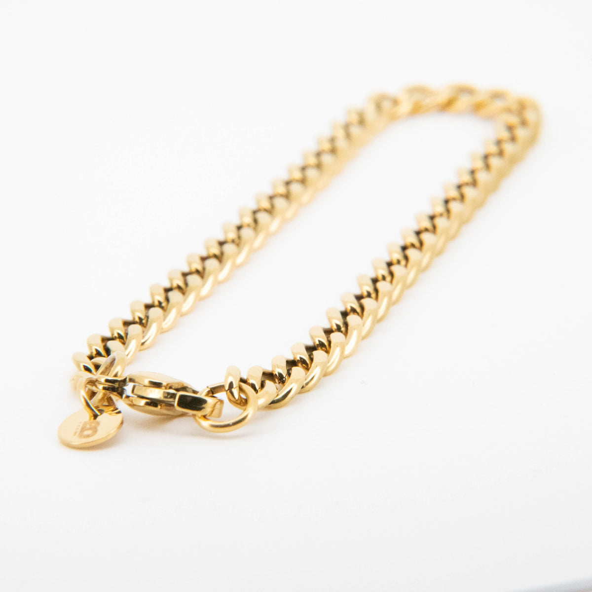 Gold-toned chain bracelet with a heart charm.