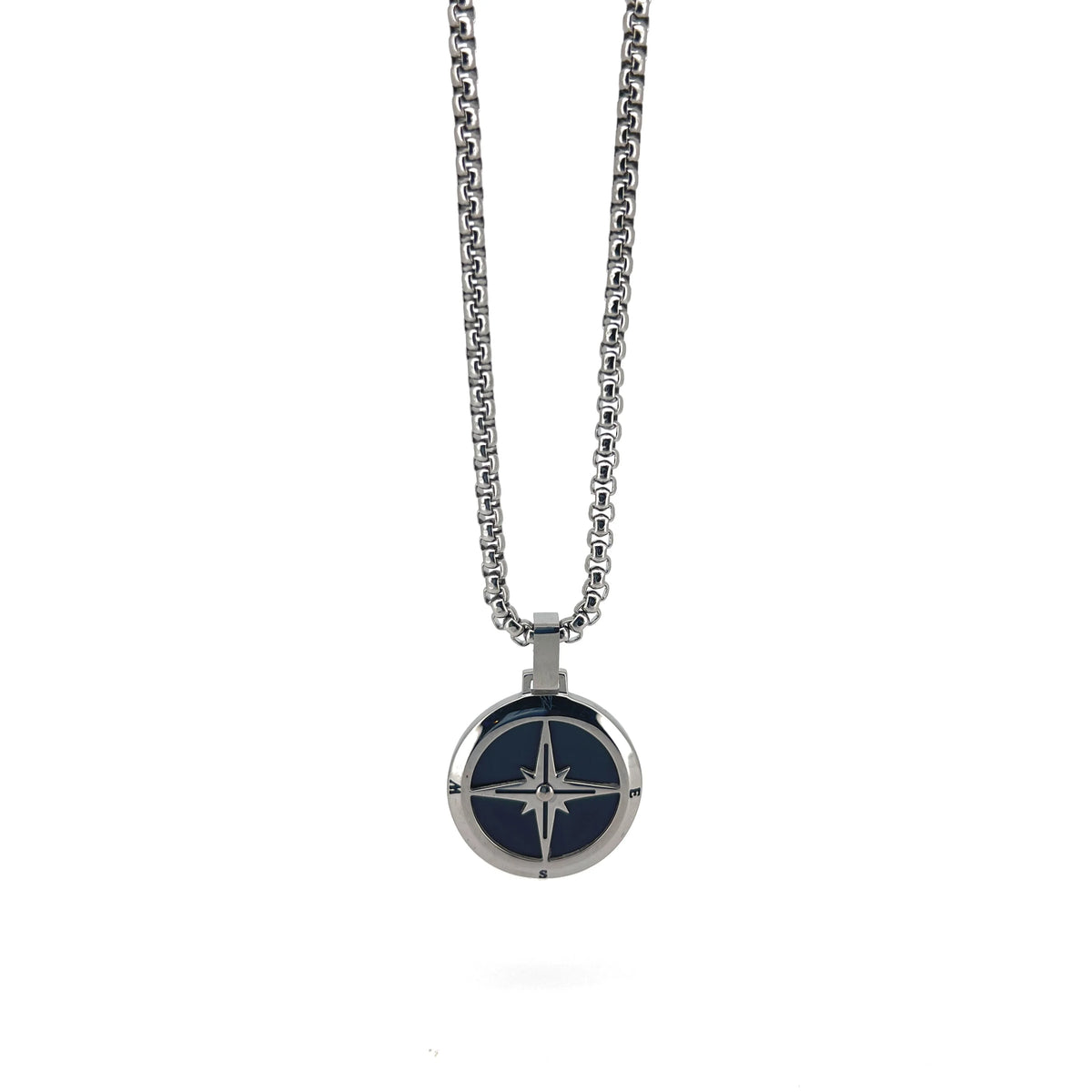 Silver pendant necklace featuring a compass rose design on a dark blue background.