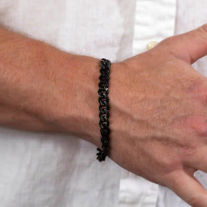 Black chain-link bracelet worn on a wrist.