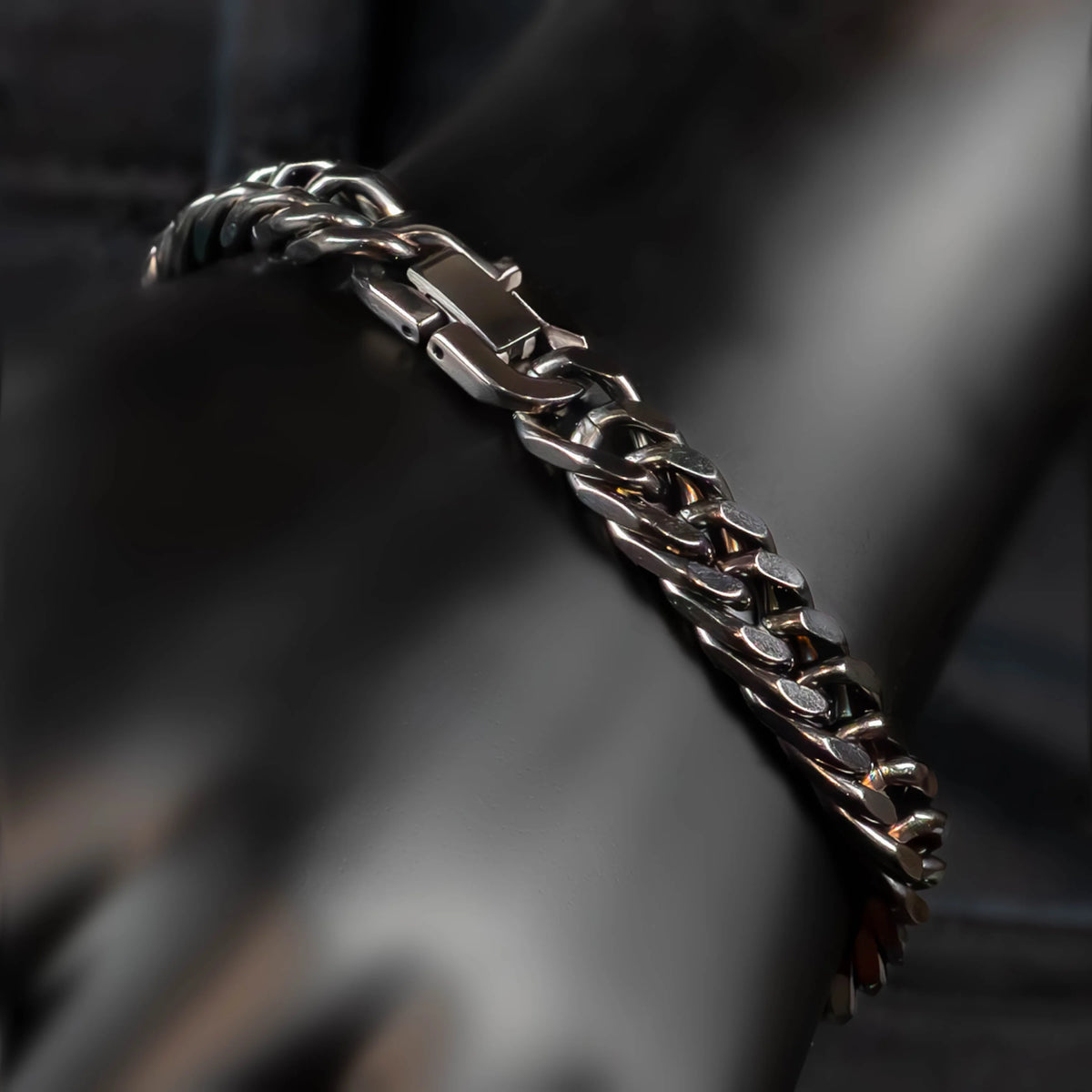 Silver chain bracelet with interlocking links.