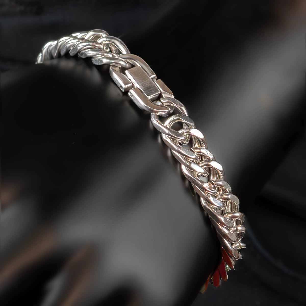 Silver chain bracelet with interlocking links and a clasp.