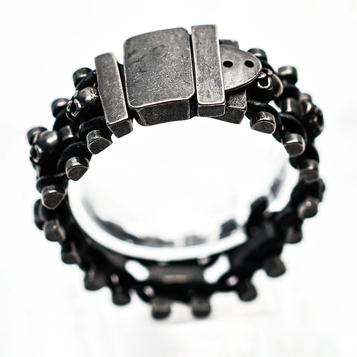 Rugged metallic ring with a chunky clasp and textured band.