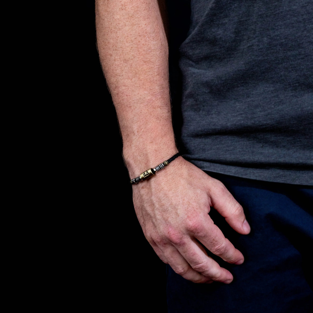 Black and silver beaded bracelet worn on a wrist.