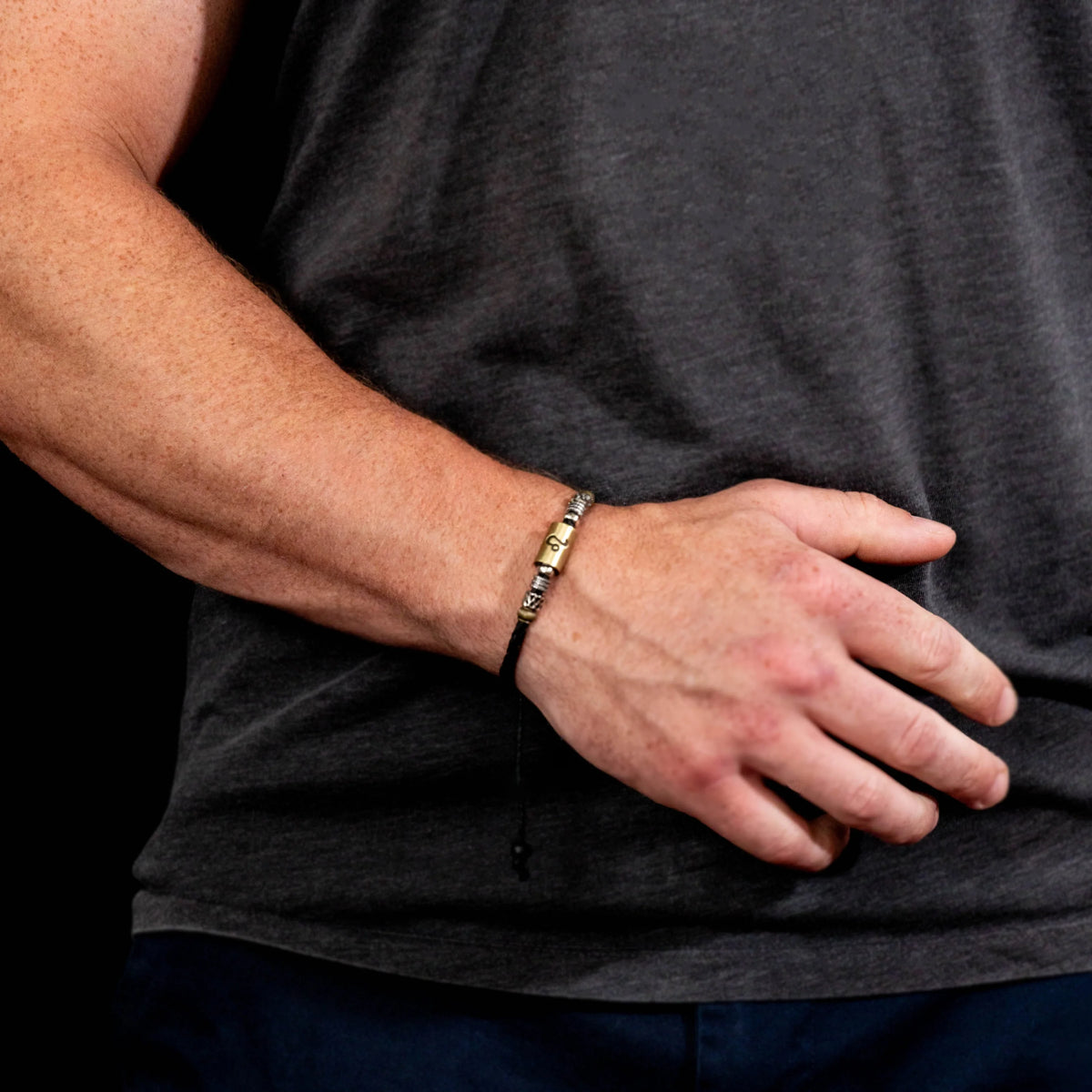 Gold and silver bracelet worn on a wrist.