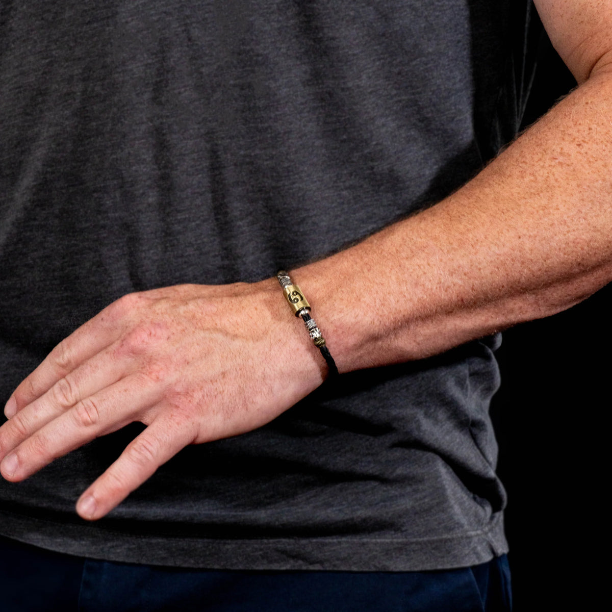 Gold and silver link bracelet worn on a wrist.