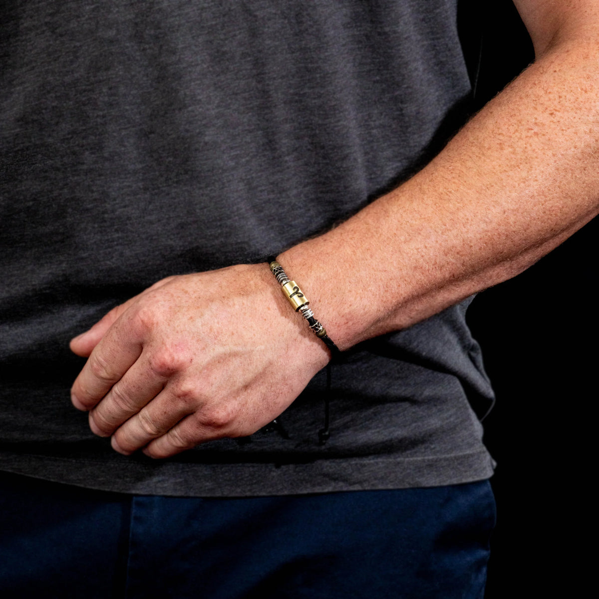 Gold and silver metal bracelet worn on a wrist.