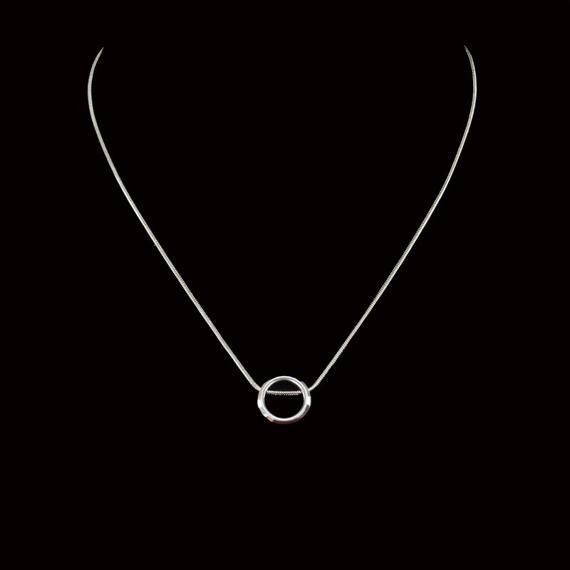 Silver necklace with a circular pendant.