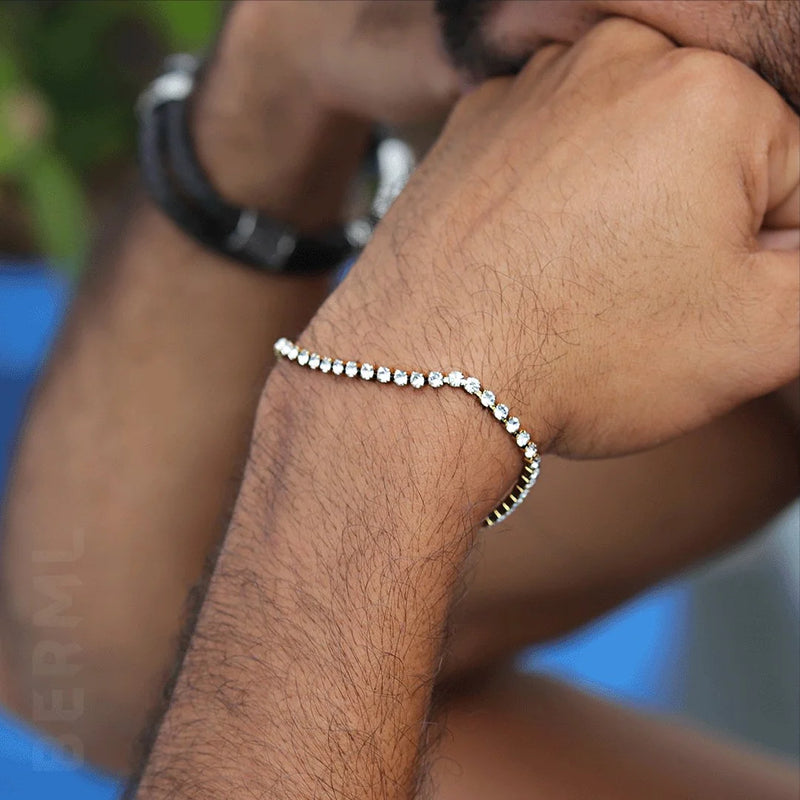 Diamond tennis bracelet worn on a hairy wrist.