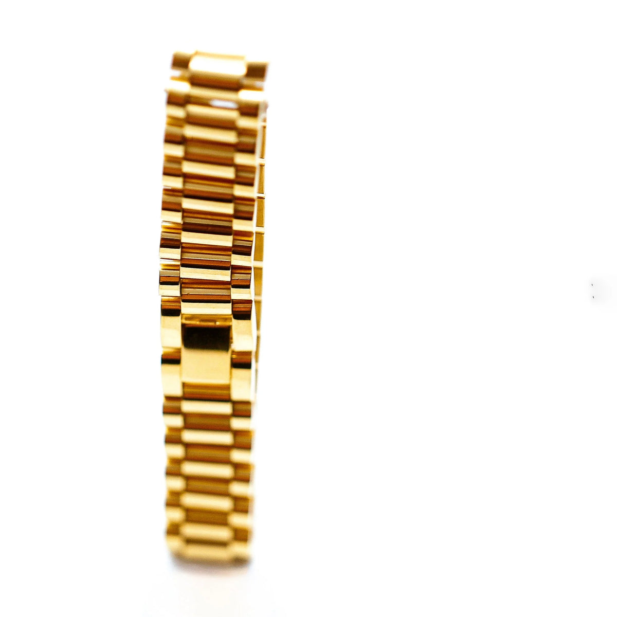 Gold watch bracelet or band with linked segments.