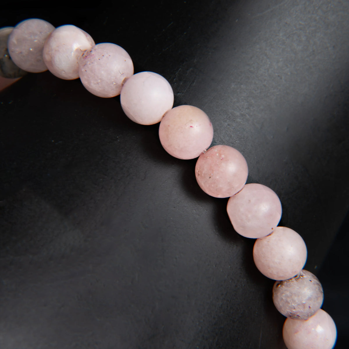 String of pale pink spherical beads.