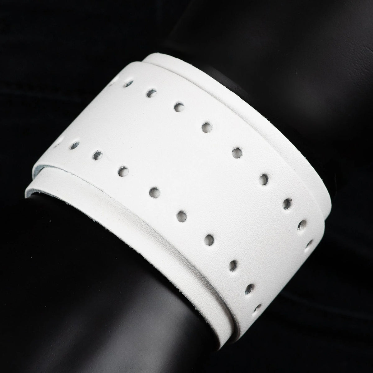 White perforated leather cuff bracelet.