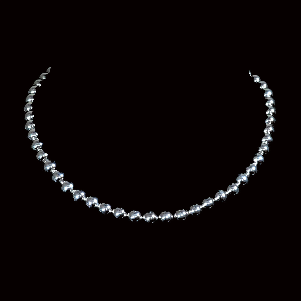 Silver beaded necklace or choker with graduated spherical beads.