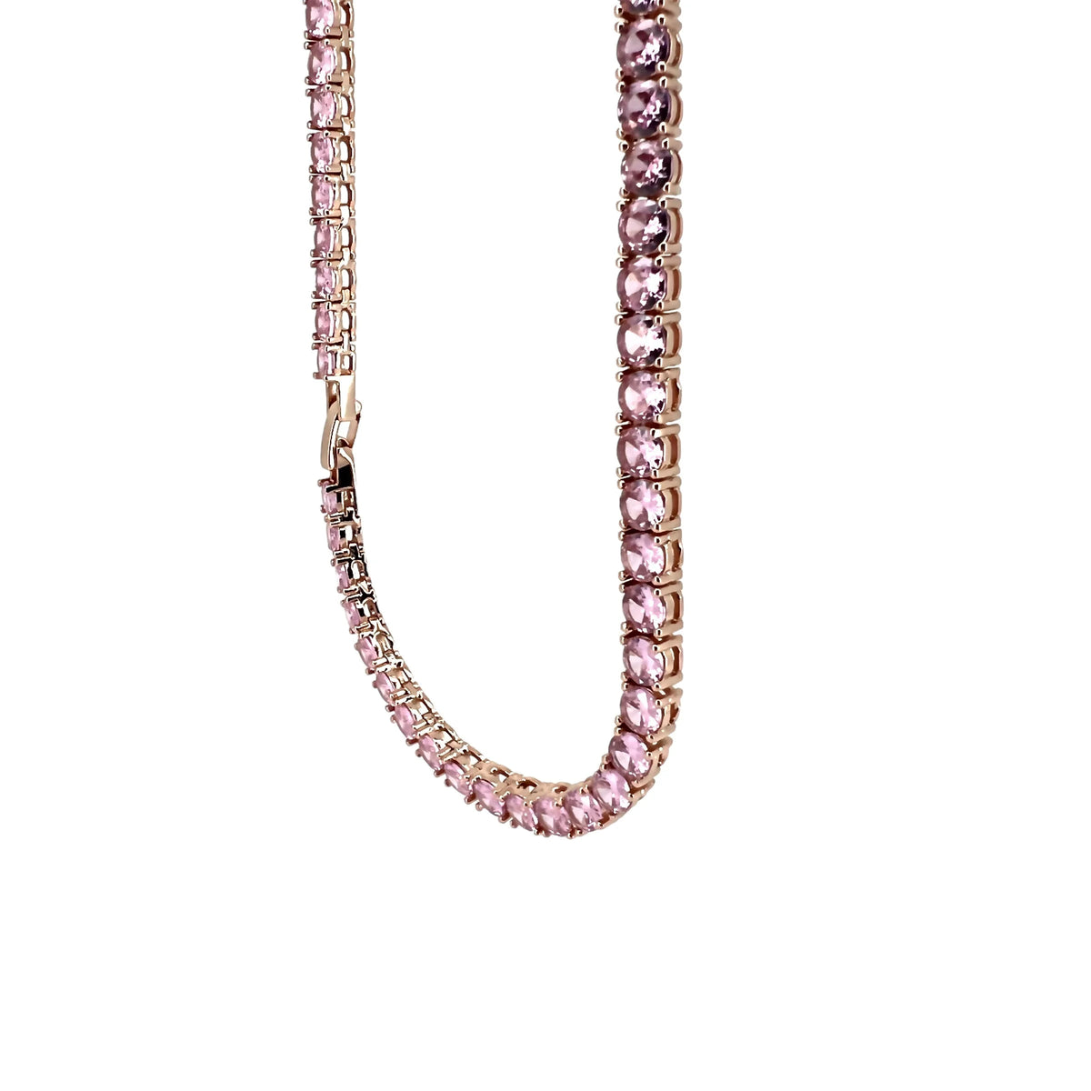 Pink gemstone tennis necklace with a gold-toned setting.