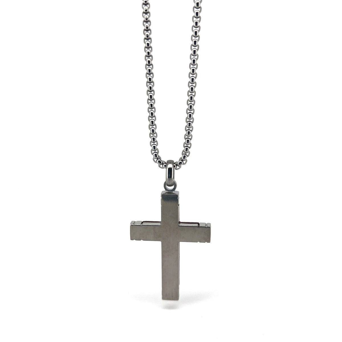 Silver cross pendant on a chain necklace.