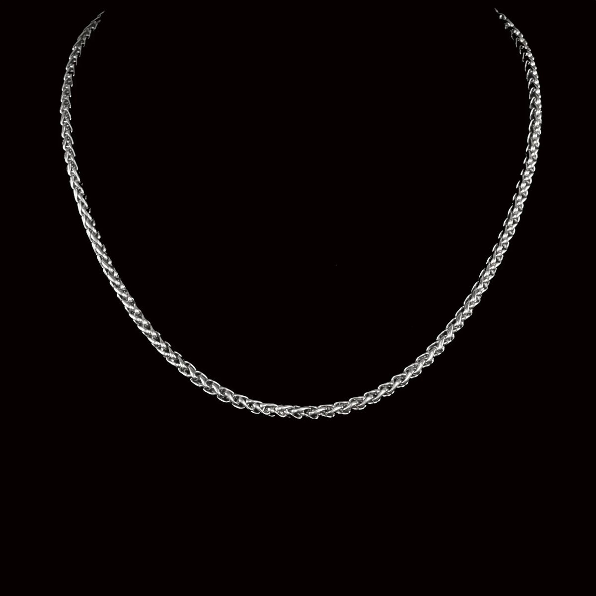 Silver braided chain necklace with an interwoven rope-like pattern.