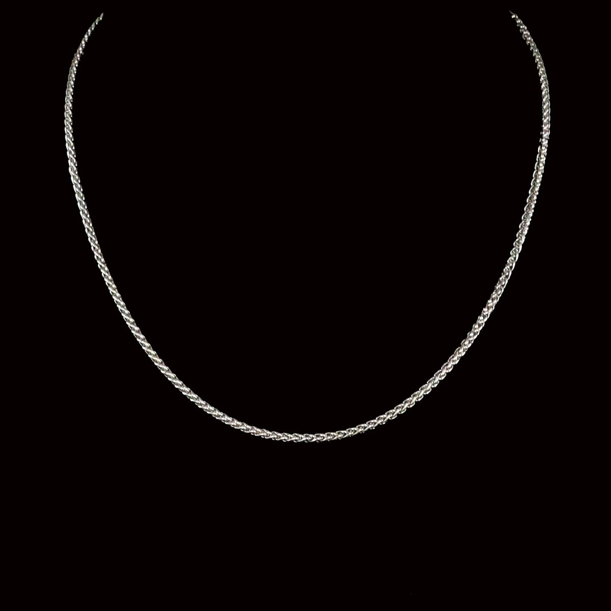 Silver chain necklace with a delicate braided design.