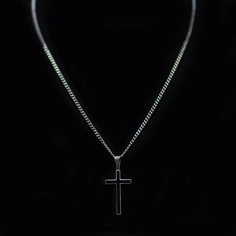 Silver cross pendant necklace on a thin chain.