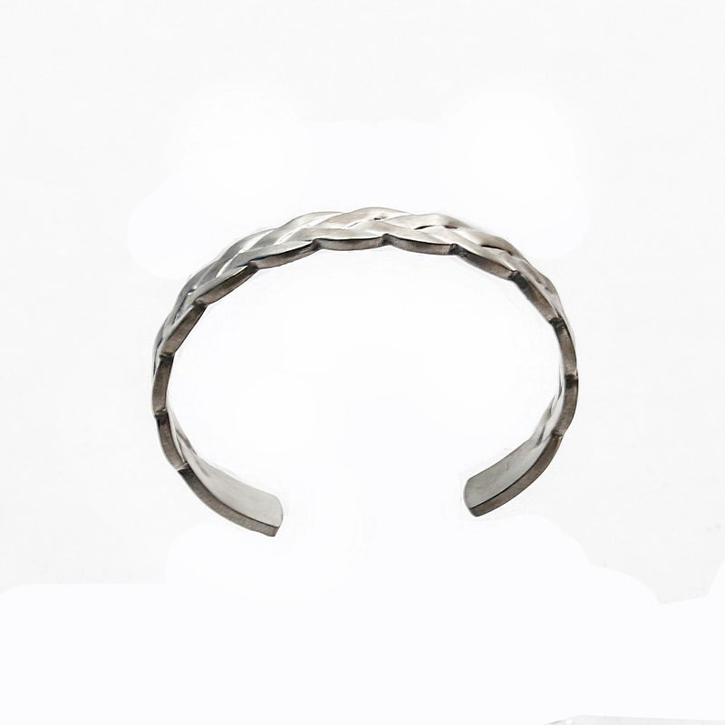 Silver braided cuff bracelet with an open design.