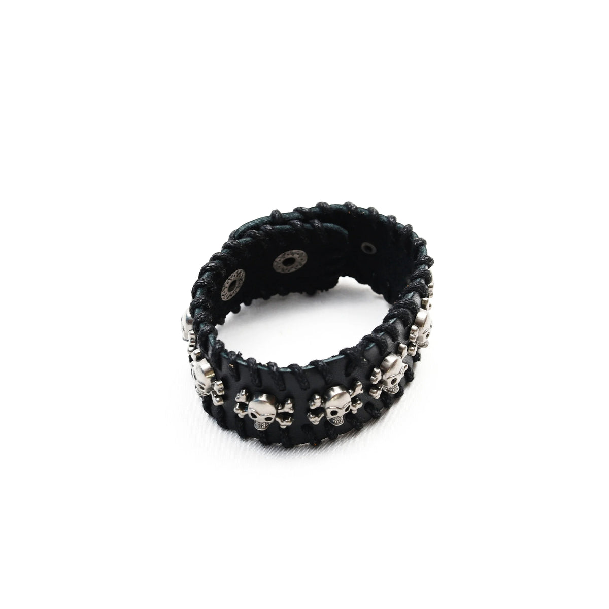 Black leather bracelet adorned with silver skull-shaped studs.