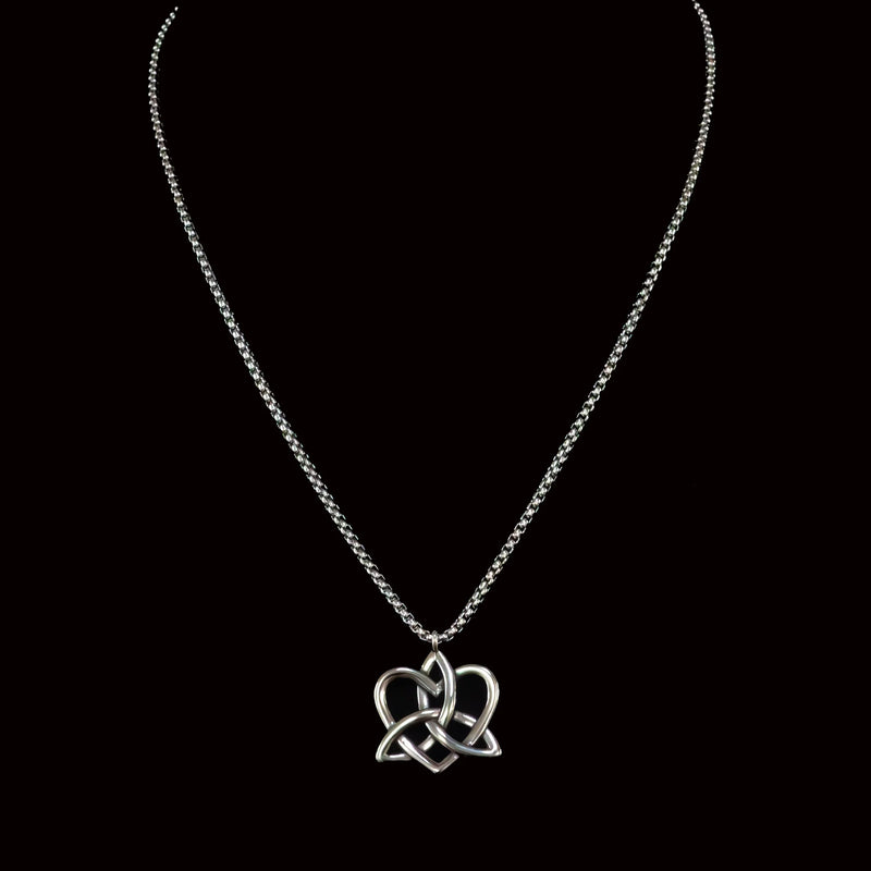 Silver necklace with a Celtic-inspired heart and trinity knot pendant.