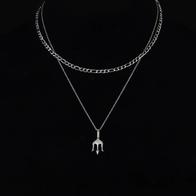 Layered silver necklace with a trident-shaped pendant.